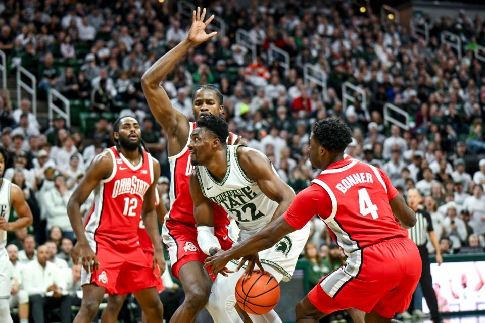 Michigan State's Mady Sissoko, center, is stripped by Ohio State's Dale Bonner during the second half on Sunday, Feb. 25, 2024, at the Breslin Center in East Lansing.