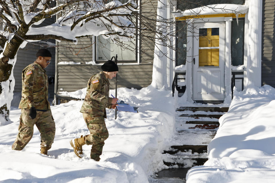 National guard members check on residents, Wednesday, Dec. 28, 2022, in Buffalo N.Y., following a winter storm. (AP Photo/Jeffrey T. Barnes)