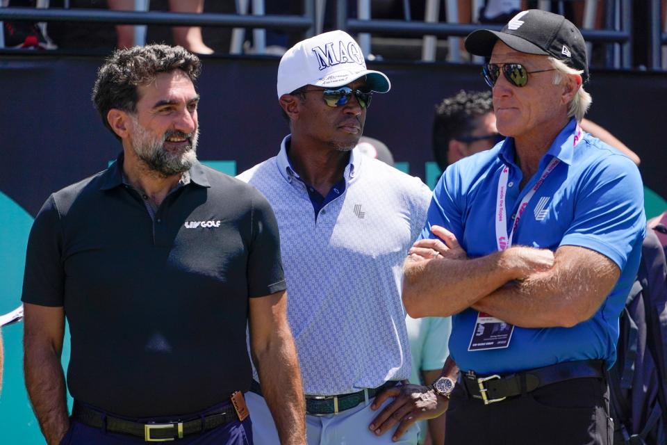 Yasir Al-Rumayyan, governor of Saudi Arabia's Public Investment Fund, left, Majed Al-Sorour, CEO of Golf Saudi, center, and Greg Norman, CEO of LIV Golf, watch at the first tee during the second round of the Bedminster Invitational LIV Golf tournament in Bedminster, N.J., on July 30, 2022.