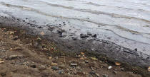 This photo taken and provided by Sunil Dowarkasing, showing oil polluting the foreshore on the eastern side of Mauritius, after it leaked from the MV Wakashio, a bulk carrier ship that recently ran aground off the southeast coast of Mauritius, Sunday, Aug. 9, 2020. Residents of the Indian Ocean island nation of Mauritius are stuffing fabric sacks with sugar cane leaves to create makeshift oil spill barriers as tons of fuel has leaked from a grounded ship. (Sunil Dowarkasing via AP)