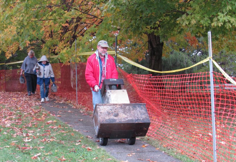 Bryan Menke and other members of the Stow Historical Society transport artifacts from the Heritage House. The historic structure was heavily damaged in an early Sunday morning fire.