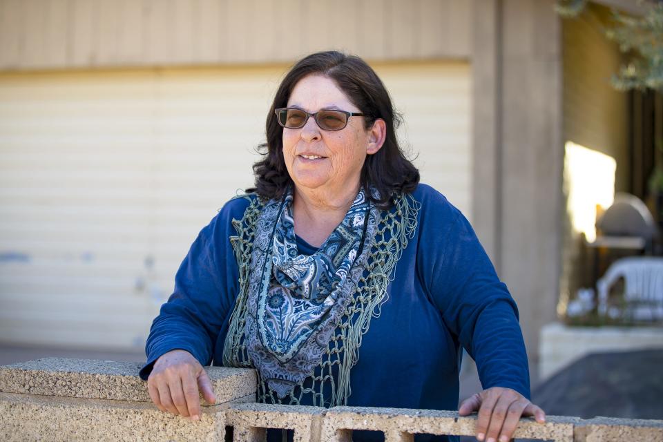 Deborah Torzone stands in front of her Tempe house on April 8, 2022. Months after applying for mortgage assistance and discovering her bank was hindering the process, she finally received $20,000 in aid.