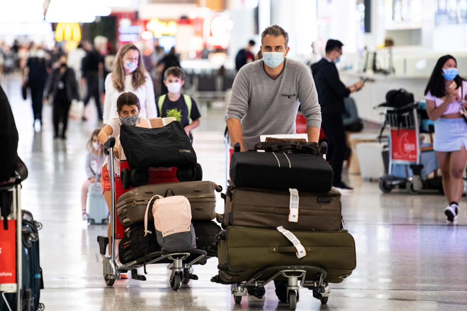 Image: Travellers arrive at the international terminal at Sydney Airport in Sydney (James Gourley / Reuters)