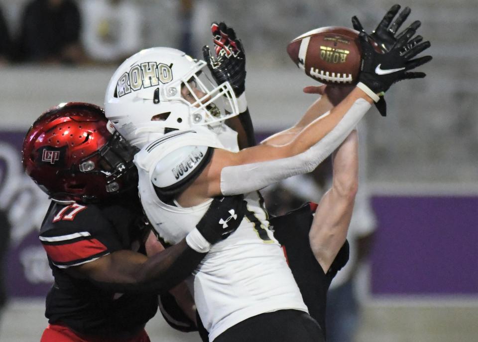 Rider receiver Reese Frantom attempts a catch as Lubbock-Cooper's Ja'Raylin Shaw (17) defends in the Region I-5A Division II final Friday, Dec. 3, 2021, at Wildcat Stadium in Abilene.