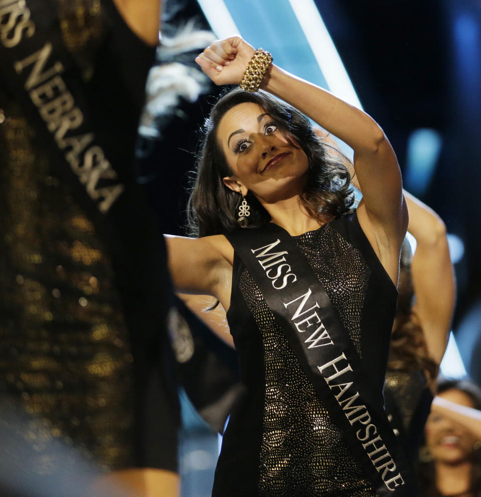 Miss New Hampshire Samantha Russo dances while walking with other contestants during the Miss America 2014 pageant, Sunday, Sept. 15, 2013, in Atlantic City, N.J. (AP Photo/Julio Cortez)