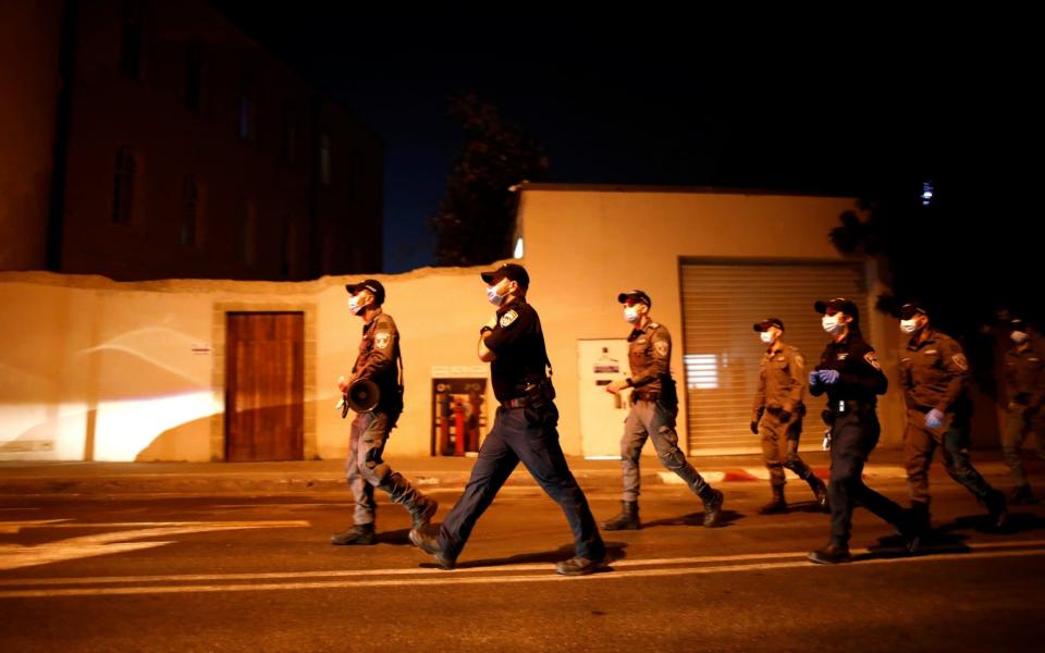 Police officers patrol as protesters take part in a demonstration against Israeli Prime Minister Benjamin Netanyahu's alleged corruption - Reuters