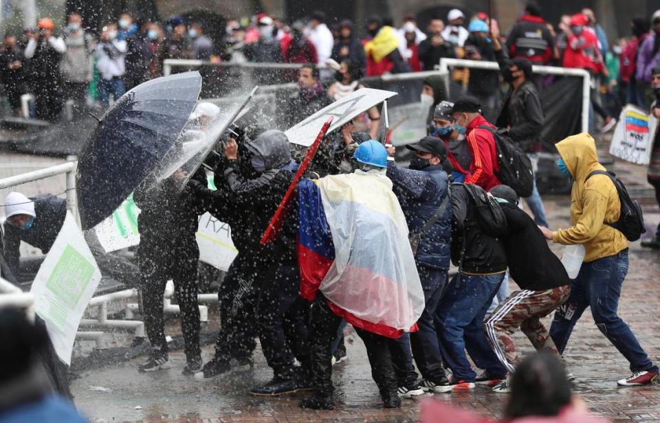 Anti-government protesters clash with police in Bogota, Colombia, Wednesday, May 5, 2021. The protests that began last week over a tax reform proposal continue despite President Ivan Duque’s withdrawal of the tax plan on Sunday, May 2. (AP Photo/Fernando Vergara)