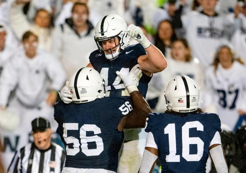 Penn State offensive lineman JB Nelson lifts up tight end Tyler Warren to celebrate his touchdown during the game against Iowa on Saturday, Sept. 23, 2023.