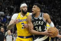 Milwaukee Bucks' Giannis Antetokounmpo tries to drive on Los Angeles Lakers' Anthony Davis during the second overtime of an NBA basketball game Tuesday, March 26, 2024, in Milwaukee. The Lakers won 128-124 in double overtime. (AP Photo/Morry Gash)