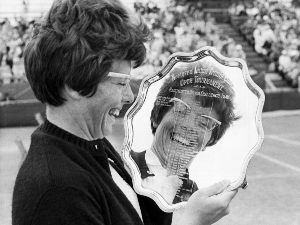 American tennis player Billie Jean King holds the Manchester Silver Challenge Tray after winning the tournament in 1966.