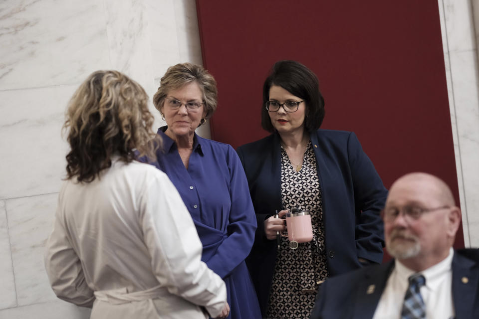 West Virginia Delegate Amy Summers, R-Taylor, center, and Heather Tulley, R-Nicholas, right, speak with a doctor on hand prior to legislative session in the House Chambers at the Capitol in Charleston, W.Va., on Wednesday, Jan. 25, 2024. West Virginia has the least amount of female state legislators.(AP Photo/Chris Jackson)