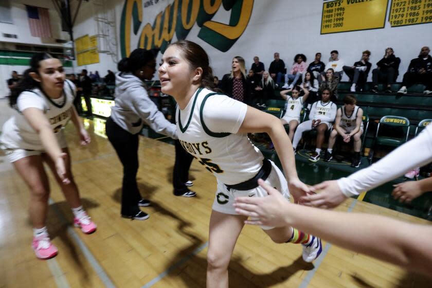 Canyon Country, CA - January 26: Isabella Escribano is greeted by teammates prior to a girls basketball game between Canyon High School and Valencia High School at Canyon High School on Friday, Jan. 26, 2024 in Canyon Country, CA. (Ringo Chiu / For Los Angeles Times en Espanol)