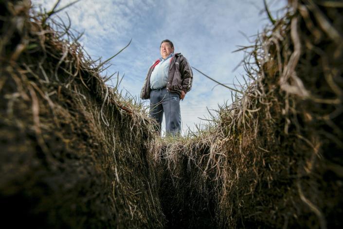 Thawing permafrost can cause the ground to sink and crack in places, destabilizing roads and buildings. <a href="https://www.gettyimages.com/detail/news-photo/cab-driver-lars-thomsen-stands-above-a-huge-gap-in-the-news-photo/600006198" rel="nofollow noopener" target="_blank" data-ylk="slk:Orjan F. Ellingvag/Corbis via Getty Images" class="link ">Orjan F. Ellingvag/Corbis via Getty Images</a>