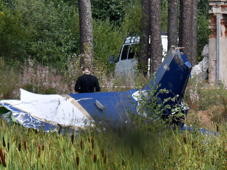 A law enforcement officer works at the site of a plane crash near the village of Kuzhenkino, Tver region, Russia, August 24, 2023. Yevgeny Prigozhin, head of the Wagner group that led a mutiny against Russia's army in June, was on the list of passengers. / Credit: OLGA MALTSEVA/AFP via Getty Images