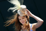 A racegoer poses for photographers on 'Ladies Day' on the first day of the Epsom Derby Festival in Surrey, southern England, on June 3, 2011. The Epsom Derby race will be run Saturday June 4, 2011. AFP PHOTO / BEN STANSALL (Photo credit should read BEN STANSALL/AFP/Getty Images)