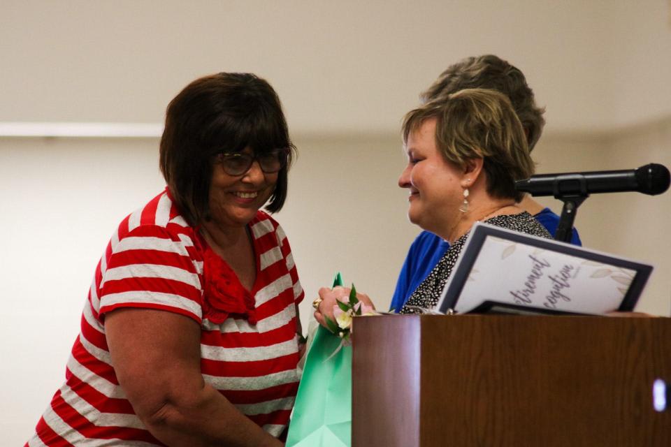 Andra Bunch (left) is honored among 27 other USD 305 retirees at a ceremony May 7.