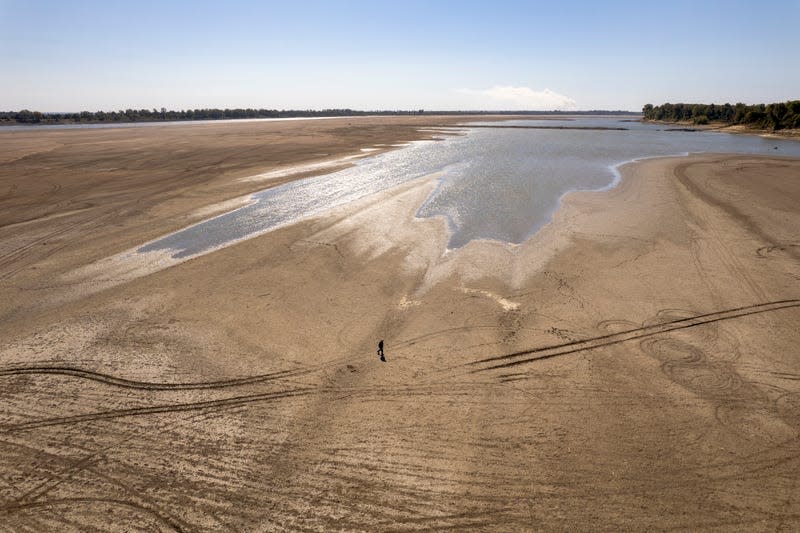 James Isaacks walks where the normally wide Mississippi River would flow, Oct. 20, 2022, near Portageville, Mo.