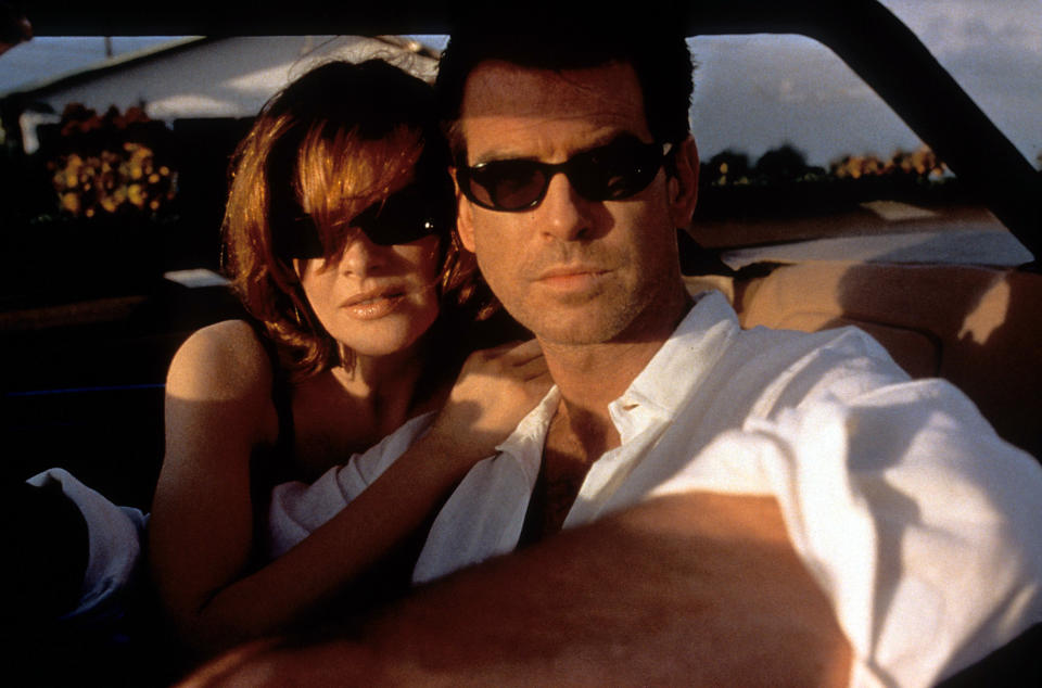 Pierce Brosnan and Rene Russo sitting in a car together in a scene from the film 'The Thomas Crown Affair', 1999. (Photo by Metro-Goldwyn-Mayer/Getty Images)