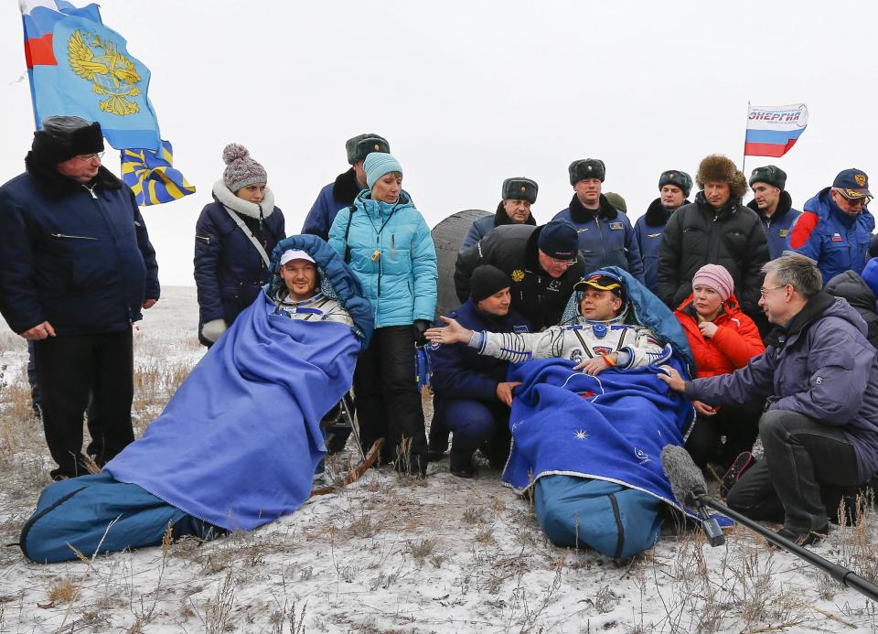 REFILE - CLARIFYING DATE OF LANDING IN SECOND SENTENCE International Space Station (ISS) crew member Maxim Suraev of Russia (R) gestures to his teammate Alexander Gerst of Germany after landing in a remote area near the town of Arkalyk in northern Kazakhstan November 10, 2014. Veteran Russian cosmonaut Suraev and two International Space Station crewmates, NASA's Reid Wiseman from the United States and Gerst from Germany, returned safely to Earth on Monday with a parachute landing of their Soyuz capsule in Kazakhstan, ending 5-1/2 months in orbit. REUTERS/Shamil Zhumatov (KAZAKHSTAN - Tags: SCIENCE TECHNOLOGY)