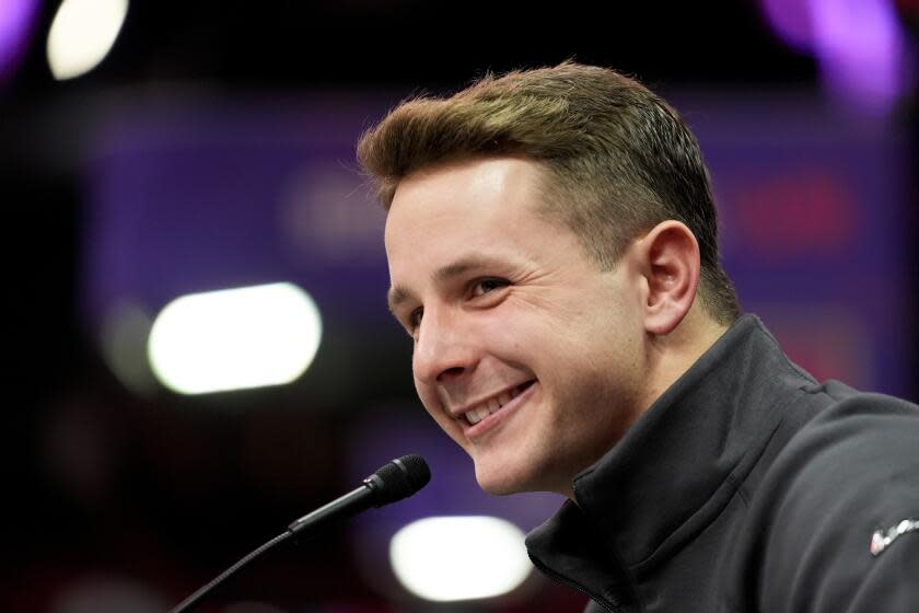 San Francisco 49ers quarterback Brock Purdy smiles while speaking to reporters during Super Bowl Opening Night.