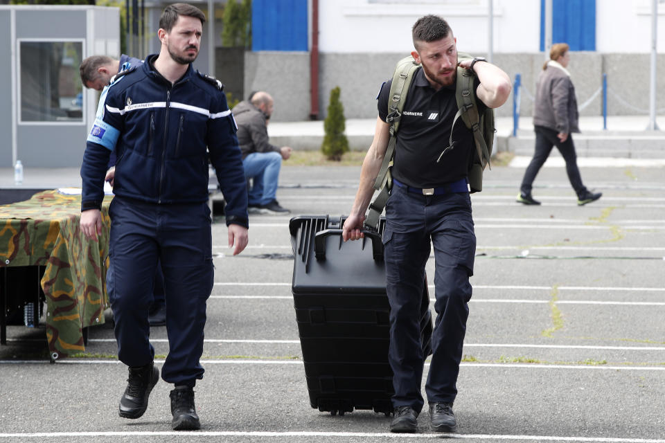 French member of Frontex Standing Corps carries equipment during the official launch of the Frontex Joint Operation in North Macedonia, at police barracks in Skopje, North Macedonia, on Thursday, April 20. 2023. (AP Photo/Boris Grdanoski)