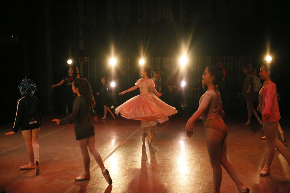 Young dancers perform on stage during a rehearsal of Vladimir Issaev's rendition of The Nutcracker ballet on Friday, Dec. 13, 2019, in Fort Lauderdale, Fla. More than 20 dancers of Venezuelan origin were playing various roles on a recent performance of the holiday favorite “The Nutcracker.” Some of these dancers are here seeking asylum after fleeing their crisis-torn nation, which is plagued by shortages of food and medicine. (AP Photo/Brynn Anderson)