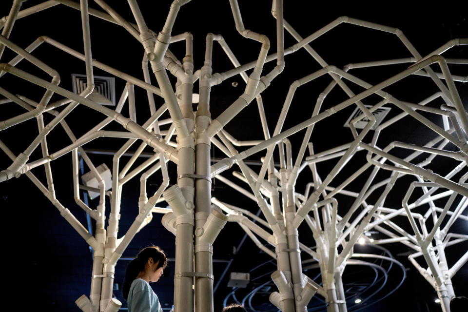 A child passes under a water piping exhibit at the NEWater visitor center in Singapore, Tuesday, July 18, 2023. Singapore has become a global hub for water technology, being home to nearly 200 water companies and over 20 research centers and hosts a biennial International Water Week. (AP Photo/David Goldman)