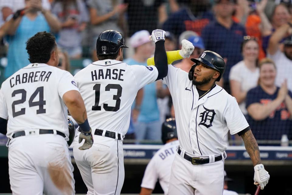 Detroit Tigers catcher Eric Haase, center, is greeted by Harold Castro, right, after the two-run home run that also scored Miguel Cabrera in the fourth inning of Tuesday night's game against the Guardians. [Carlos Osorio/Associated Press]