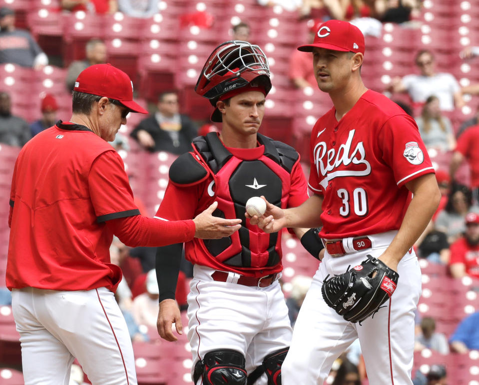 Apr 28, 2022; Cincinnati, Ohio, USA; Cincinnati Reds manager David Bell (left) takes the bal from Cincinnati Reds starting pitcher Tyler Mahle (30) during the sixth inning against the San Diego Padres at Great American Ball Park. Mandatory Credit: David Kohl-USA TODAY Sports