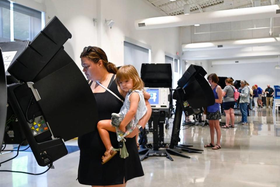 Voter Darcy Zieger of Mission held her daughter, Charlotte Zieger, 2, as she cast her ballot in the 2022 Primary Election on the first day of In Person Advance Voting Saturday, July 16, 2022, at the Johnson County Arts and Heritage Center in Overland Park.