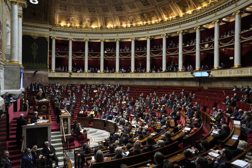 French lawmakers gather at the National Assembly in Paris, Monday, March 20, 2023. France's government is fighting for its survival Monday against no-confidence motions filed by lawmakers who are furious that President Emmanuel Macron used special constitutional powers to force through an unpopular bill raising the retirement age from 62 to 64 without giving them a vote. (AP Photo/Lewis Joly)