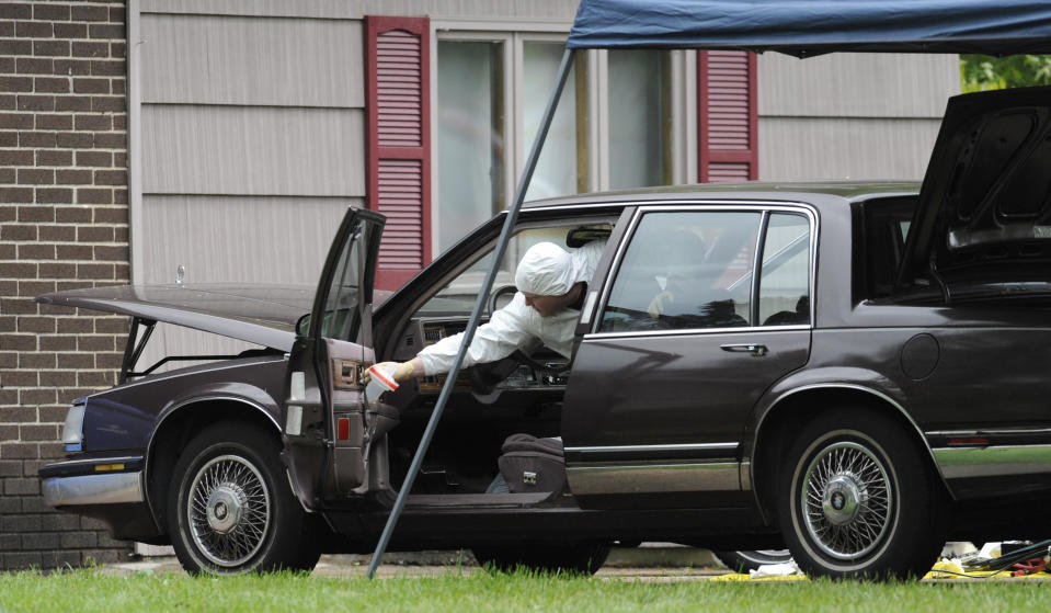 Law enforcement agents search a car at the home of reputed Connecticut mobster Robert Gentile in Manchester, Conn., Thursday, May 10, 2012. Gentile's lawyer A. Ryan McGuigan says the FBI warrant allows the use of ground-penetrating radar and believes they are looking for paintings stolen from Boston's Isabella Stewart Gardener Museum worth half a billion dollars. (AP Photo/Jessica Hill)