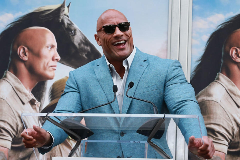 HOLLYWOOD, CALIFORNIA - DECEMBER 10: Dwayne Johnson speaks during Hand And Footprint Ceremony honoring Kevin Hart at TCL Chinese Theatre on December 10, 2019 in Hollywood, California. (Photo by Leon Bennett/WireImage)