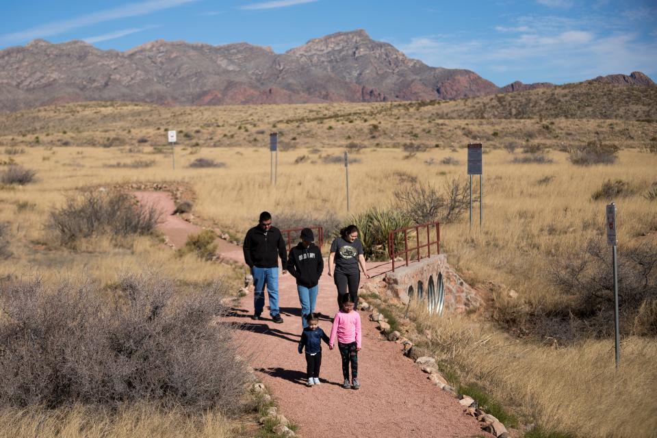 El Pasoans enjoy Castner Range National Monument by walking along a path near the El Paso Museum of Archaeology on April 1.