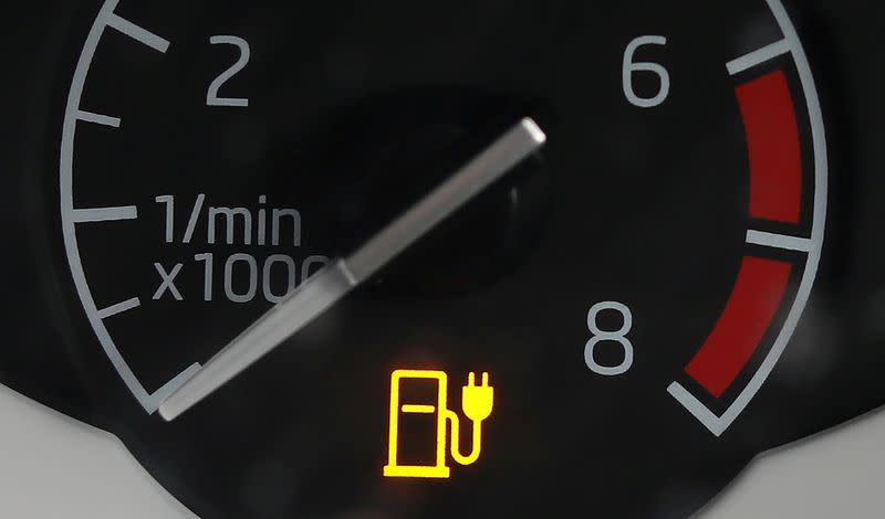FILE PHOTO: An electricity charging indicator is seen on the dashboard of a Plug-in hybrid electric car outside a house in Manchester
