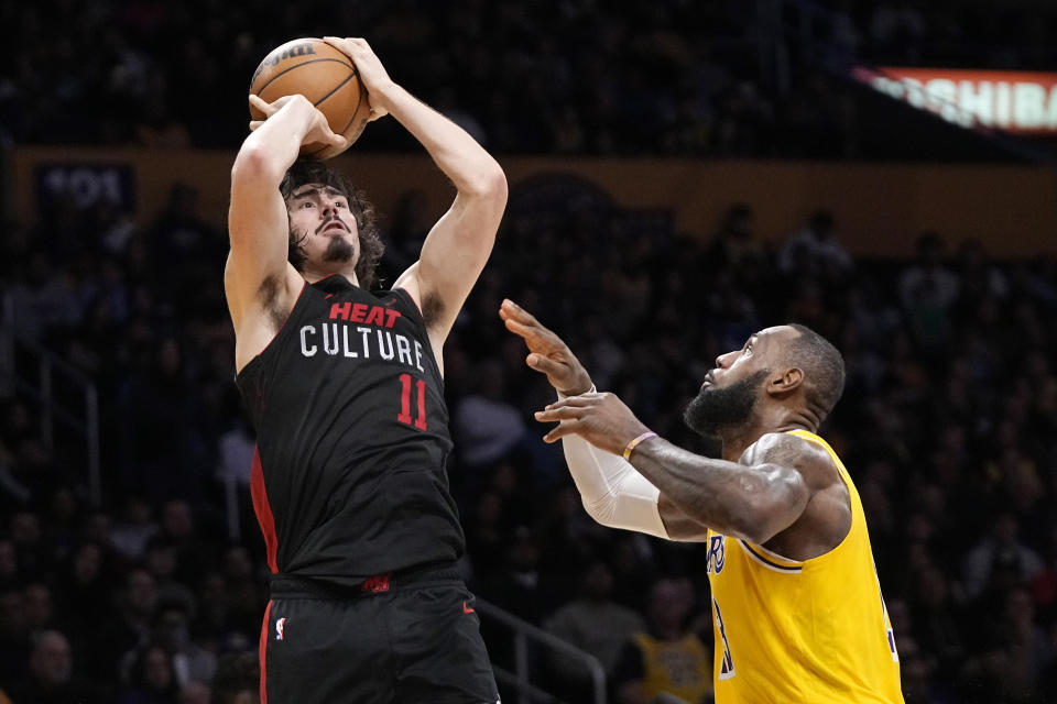 Miami Heat guard Jaime Jaquez Jr., left, shoots as Los Angeles Lakers forward LeBron James defends during the second half of an NBA basketball game Wednesday, Jan. 3, 2024, in Los Angeles. (AP Photo/Mark J. Terrill)