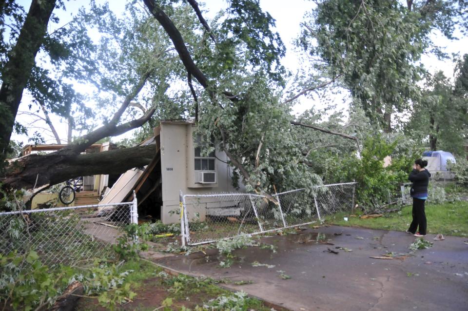 A resident of the Apollo Mobile Home Park surveys the damage to her home in Oklahoma City, Oklahoma May 7, 2015. About a dozen people were injured by a series of tornadoes that touched down southwest of Oklahoma City, part of a storm system that flattened structures and caused severe flooding in several Great Plain states, officials said on Thursday. REUTERS/Nick Oxford