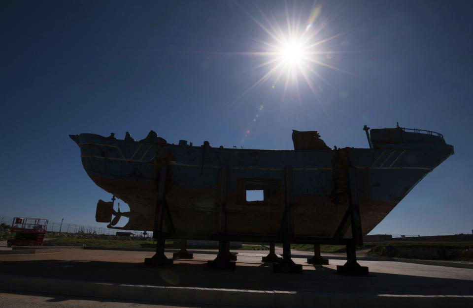 FILE - In this Saturday, Oct. 8, 2016 file photo, the wrecked fishing boat that capsized and sunk on April 18, 2015 off the coast of Libya, lies outside a NATO base in the Sicilian town of Mellili, Italy. Officials have put the number of dead in the April 2015 migrant shipwreck at between 750 and 800 people, following autopsies on the remains retrieved from inside the vessel. Only 28 people survived the accident. (AP Photo/Salvatore Cavalli, File)