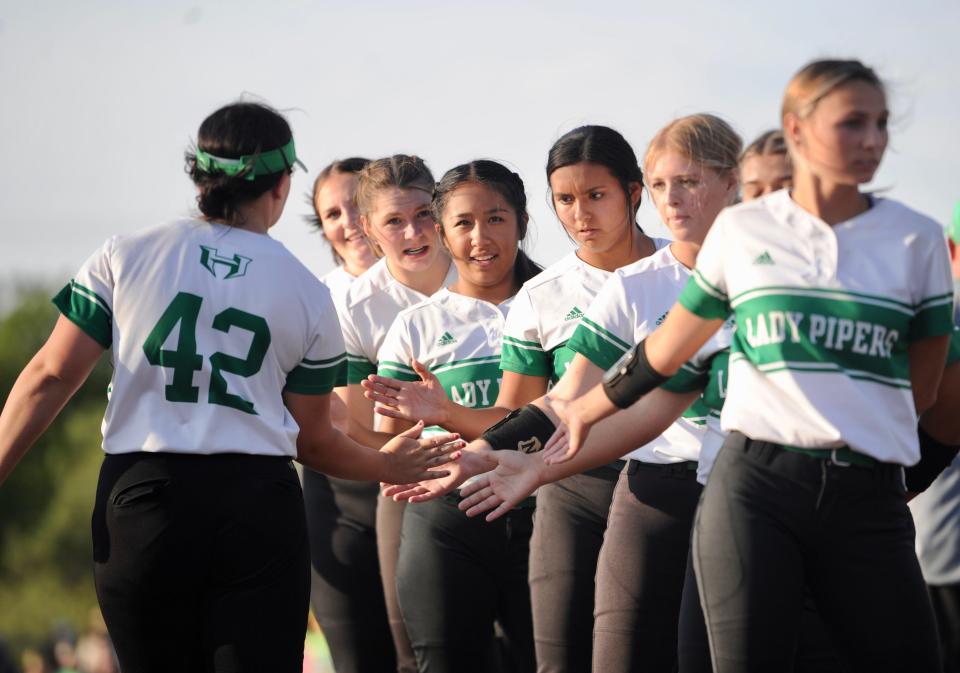 Hamlin's Cami Claterbaugh shakes teammates' hands before facing Stamford on Wednesday at ACU's Poly Wells Field.