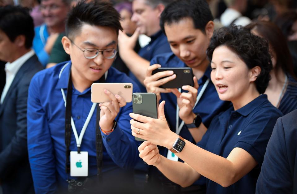 People try out a new Apple iPhone 11 Pro during an Apple product launch event at Apple's headquarters in Cupertino, California on September 10, 2019. - Apple unveiled its iPhone 11 models Tuesday, touting upgraded, ultra-wide cameras as it updated its popular smartphone lineup and cut its entry price to $699. (Photo by Josh Edelson / AFP)JOSH EDELSON/AFP/Getty Images ORG XMIT: Apple exp ORIG FILE ID: AFP_1K67HK