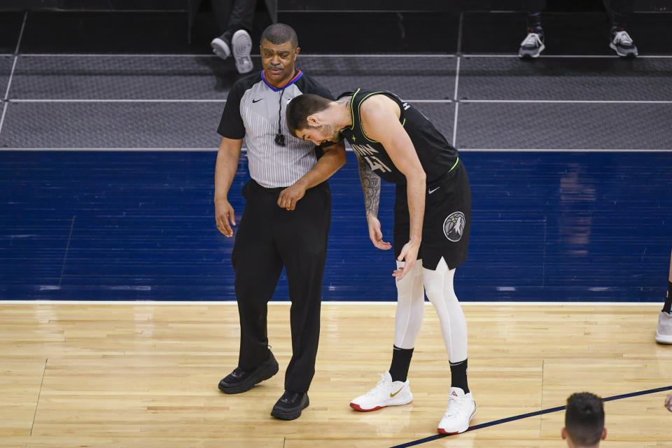 Minnesota Timberwolves forward Juancho Hernangomez (41) leans toward referee Tony Brothers to demonstrate how, he thought, Miami Heat guard Goran Dragic leaned into him to draw a foul during the first half of an NBA basketball game Friday, April 16, 2021, in Minneapolis. (AP Photo/Craig Lassig)