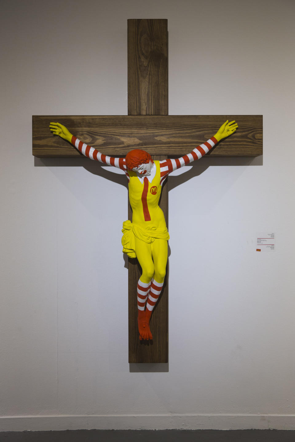 An artwork called "McJesus," which was sculpted by Finnish artist Jani Leinonen and depicts a crucified Ronald McDonald, is seen on display as part of the Haifa museum's "Sacred Goods" exhibit, in Haifa, Israel, Monday, Jan. 14, 2019. Hundreds of Christians calling for the sculpture's removal protested at the museum last week. (AP Photo/Oded Balilty)