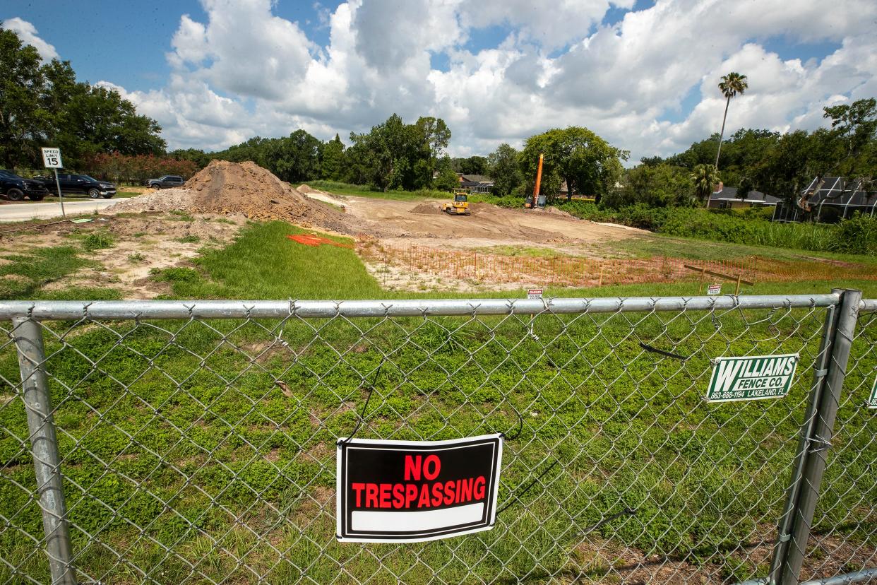 Construction crews on Wednesday finish filling in a sinkhole that opened up last week near Scott Lake Road and Aiden Lane in Lakeland.