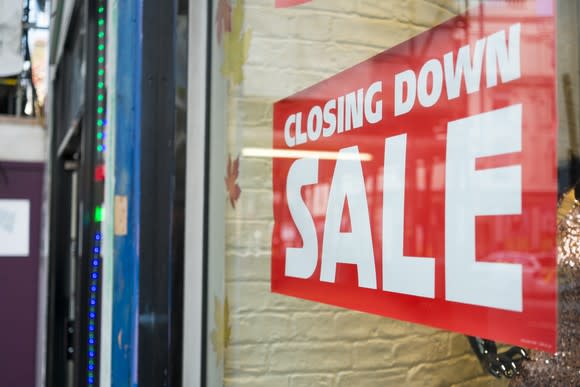 Business with closing down sign in window