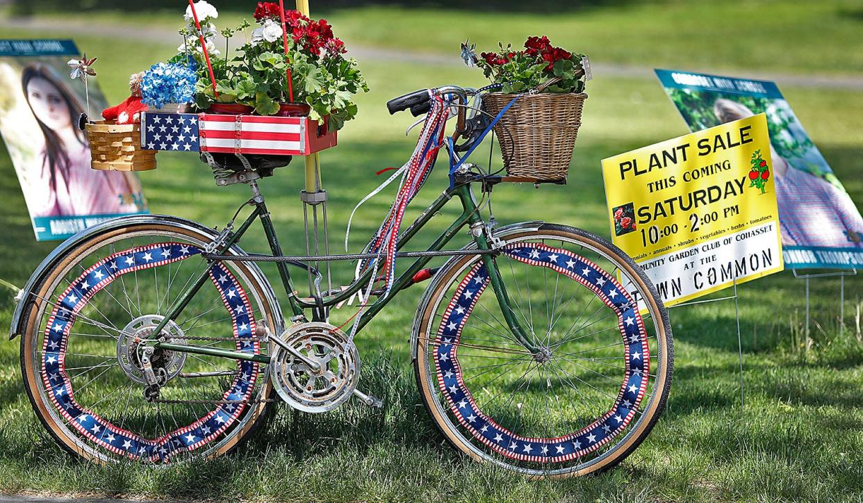 Mobile sign, a decorated bicycle and sign touting a plant sale on Cohasset Common this weekend.Tuesday May 25, 2021 Greg Derr/The Patriot Ledger