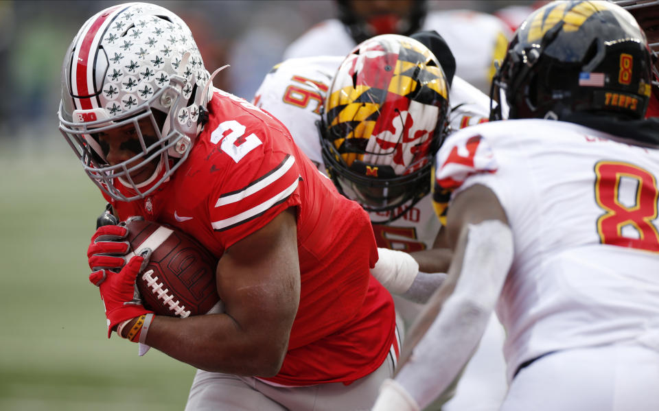 Ohio State running back J.K. Dobbins, left, breaks through the line of scrimmage to score a touchdown against Maryland during the first half of an NCAA college football game Saturday, Nov. 9, 2019, in Columbus, Ohio. (AP Photo/Jay LaPrete)