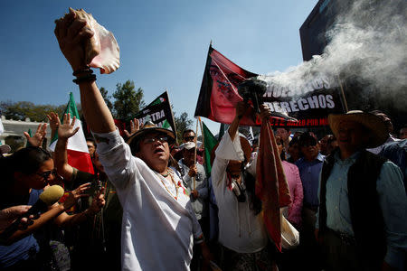 Demonstrators perform a pre-Hispanic ritual during a protest against U.S. President Donald Trump's proposed border wall, and to call for unity, in Mexico City, Mexico, February 12, 2017. REUTERS/Ginnette Riquelme