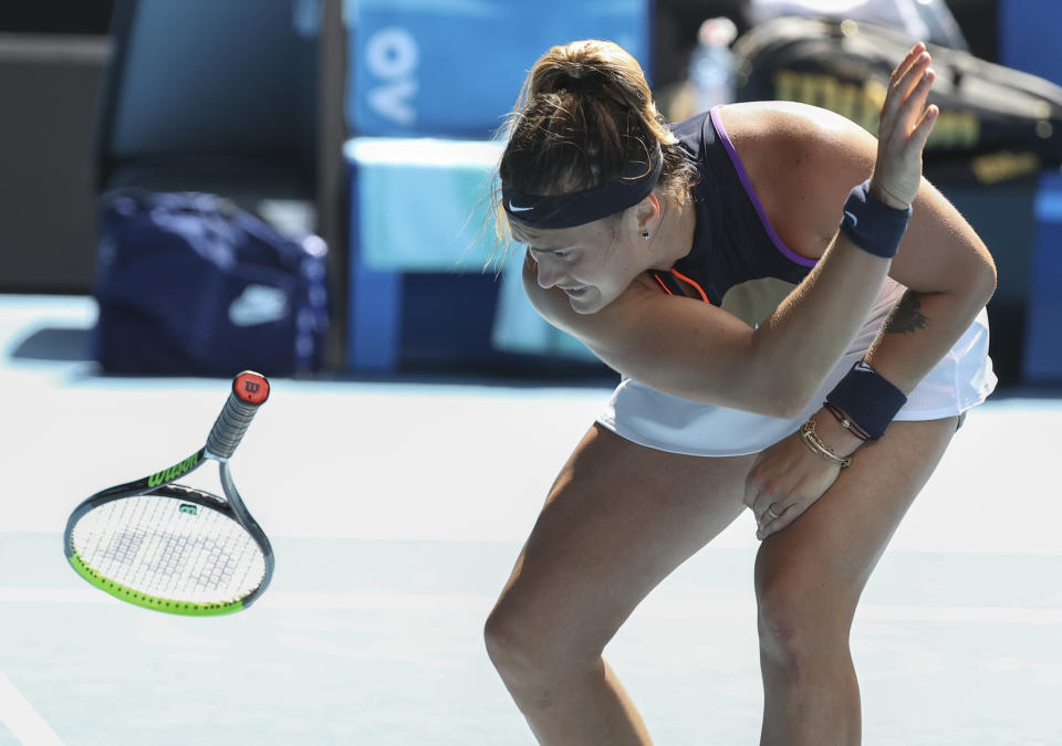Aryna Sabalenka of Belarus throws her racket in frustration during her fourth round match against United States' Serena Williams at the Australian Open tennis championship in Melbourne, Australia, Sunday, Feb. 14, 2021.(AP Photo/Hamish Blair)