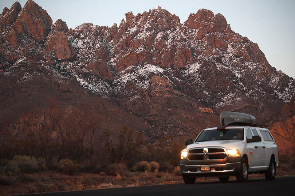 In this Thursday, March 4, 2020, photograph, a motorist carries a canoe on the roof his pickup truck while leaving the Organ Mountains Desert Peaks National Monument near Las Cruces, N.M. With events cancelled by the new coronavirus, people have turned to the great outdoors for entertainment as well as exercise in these turbulent times. The new coronavirus causes mild or moderate symptoms for most people. but for some, especially older adults and people with existing health problems, it can cause more severe illness or death. (AP Photo/David Zalubowski)