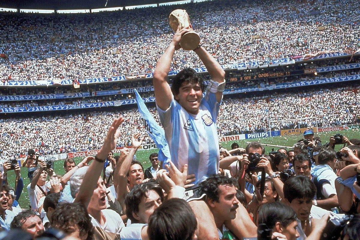 Diego Maradona with the trophy after the 1986 World Cup final (Carlo Fumagalli/AP/PA) (AP)